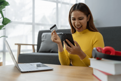 Woman excitedly using online banking on her phone