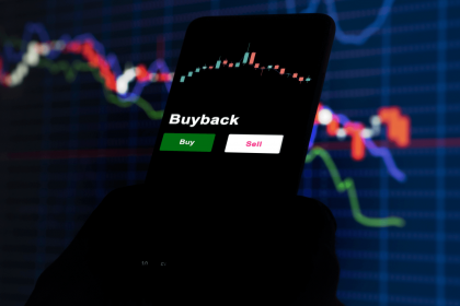 Mobile screen displaying stock buyback options with financial graphs in the background