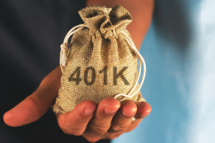 Hand holding a burlap sack labeled "401K"