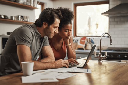 Couple reviewing their budget together on a laptop.