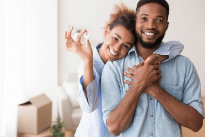 Happy couple holding keys to their new home