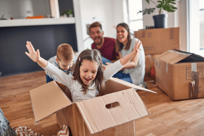 Family moving into their new home after securing mortgage insurance