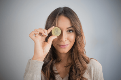 Woman holding a Bitcoin coin