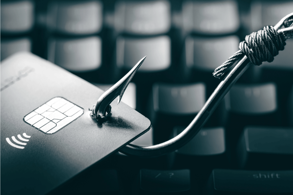 A credit card with a phishing hook, symbolizing identity theft.