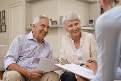 Senior couple consulting with a financial advisor at Bank of America.