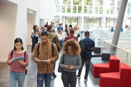 Students walking in a modern Texas university campus affected by DEI ban