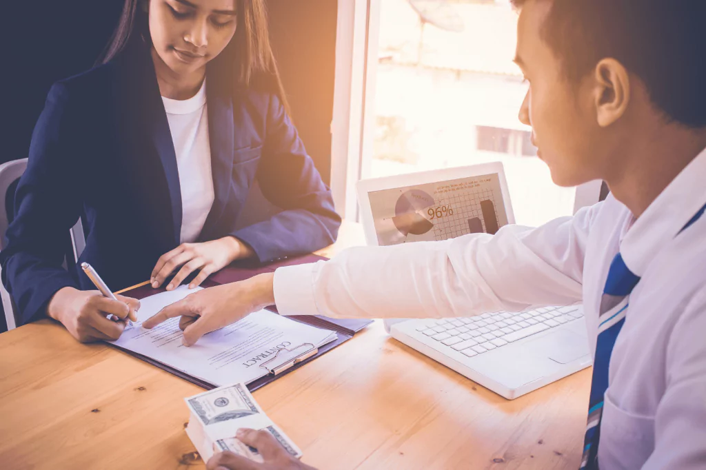 Couple discussing loan terms with a banker