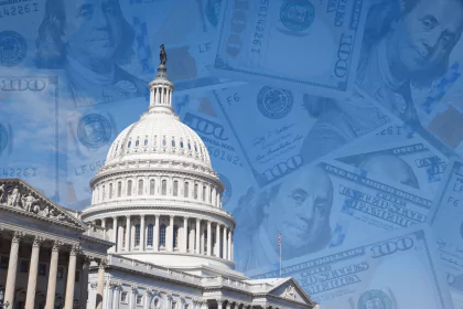 The Capitol building with overlapping images of hundred-dollar bills representing the federal deficit.
