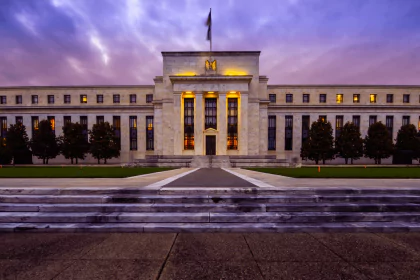 Federal Reserve building illuminated at dusk, symbolizing stability and economic policy