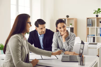 Financial advisor explaining loan options to a young couple.