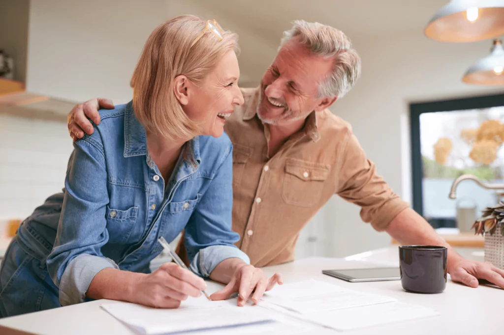 Happy elderly couple reviewing documents