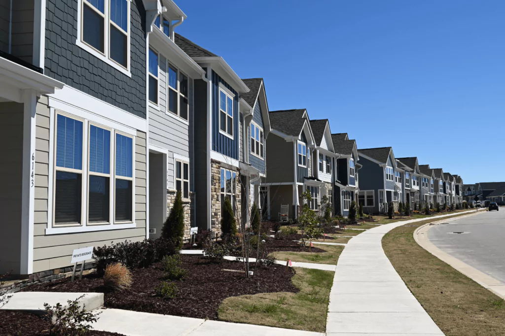 A row of modern single-family homes in a suburban neighborhood
