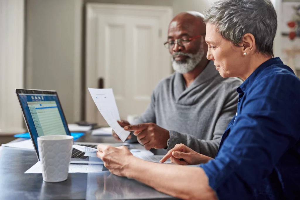 Middle-aged couple reviewing financial documents