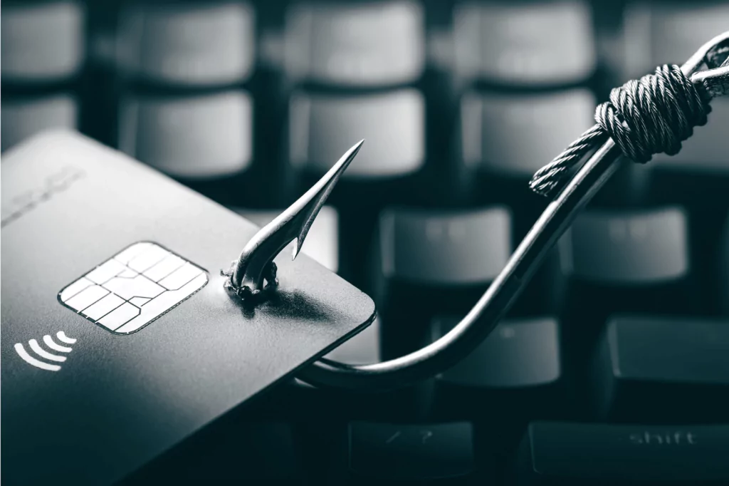 A credit card with a phishing hook, symbolizing identity theft.
