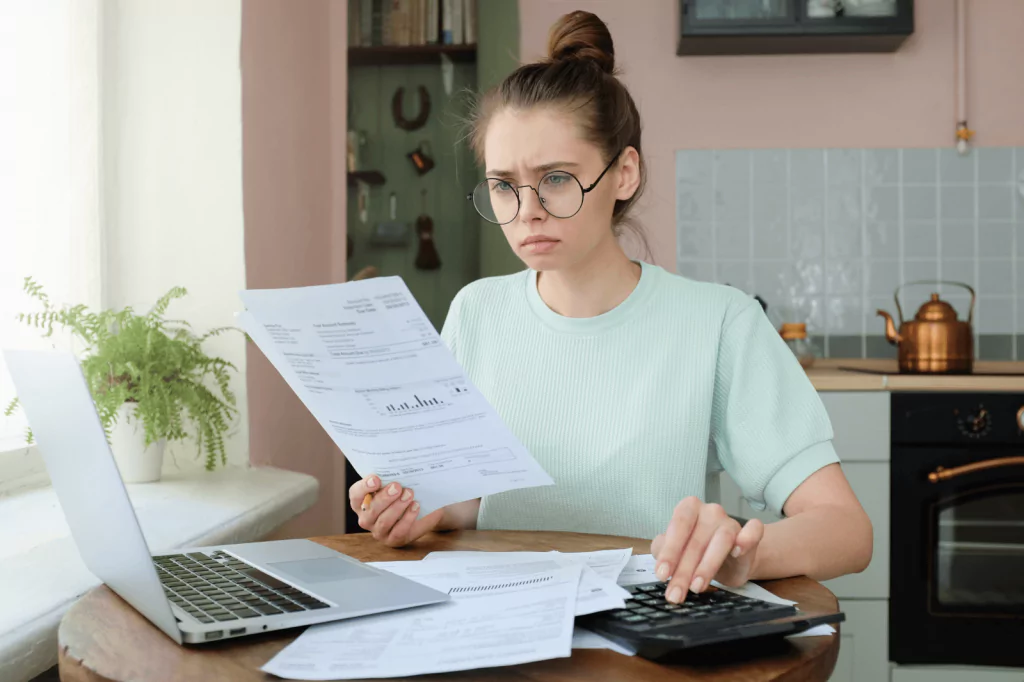 Woman reviewing financial documents to improve credit score