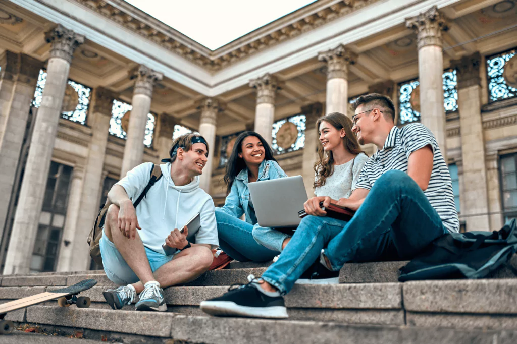 Group of students sitting outside a Texas university building