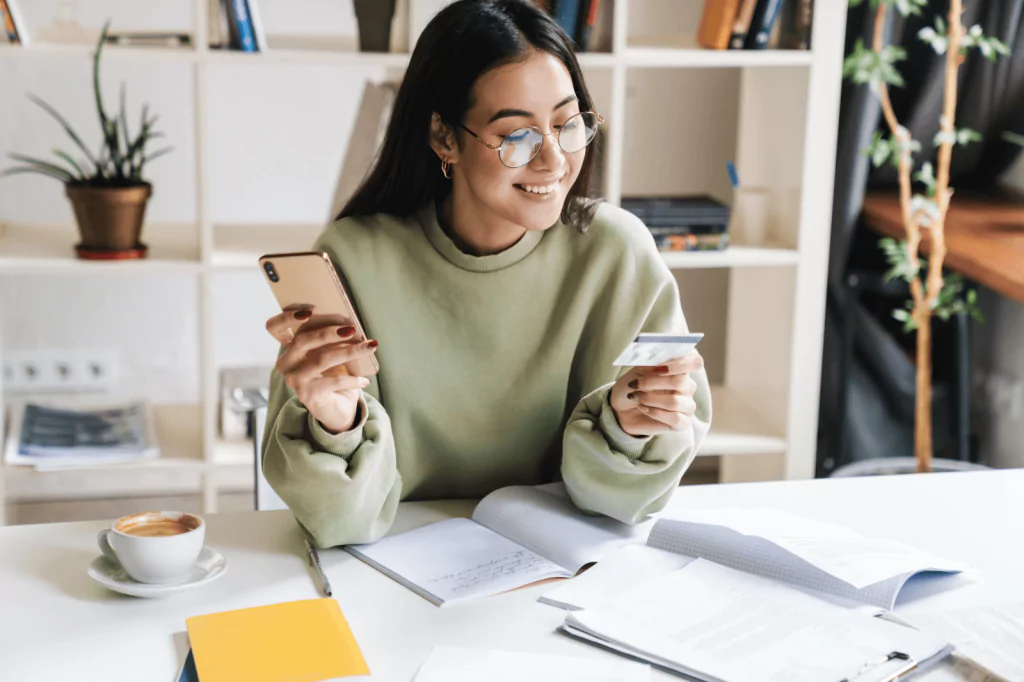 Woman updating card details online with a phone