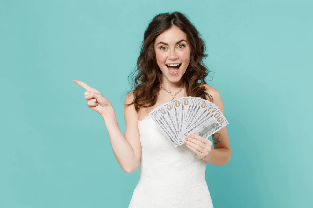 Excited bride holding cash, symbolizing a wedding loan