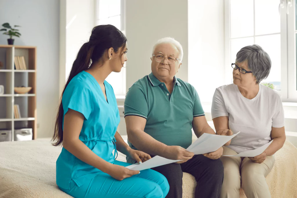 Healthcare worker consulting with elderly patients